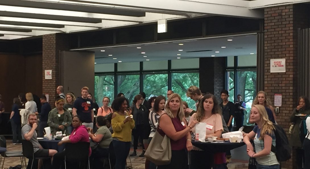 groups of attendees around tables for an IPE event in the UIC Student Center
